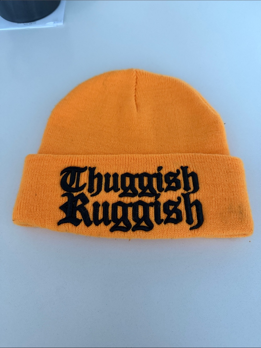 Thuggish Ruggish Orange Knit Beanie with Black Embroidered Text